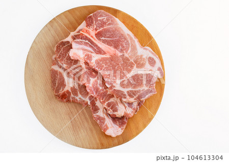 On white isolated background, there are large pieces of raw fresh meat marbling pork. On white isolated background, there are large pieces of raw fresh meat marbling pork. 104613304