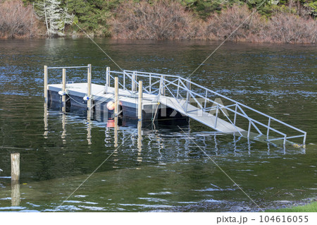 Photograph of boat moorings in flood waters at the Manapouri Boat Club in New Zealand 104616055