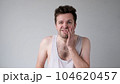 Poor caucasian man has a toothache. Studio shot 104620457