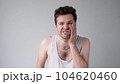 Poor caucasian man has a toothache. Studio shot 104620460
