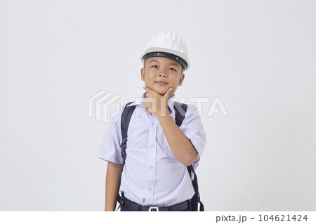 A young Asian cute boy standing in a Thai school uniform with a backpack bag and safety helmet on a white background banner A young Asian cute boy standing in a Thai school uniform with a backpack bag and safety helmet on a white background banner 104621424