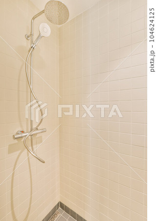 a shower with white tiles on the walls and gray gre tile flooring in a bathroom area is shown 104624125