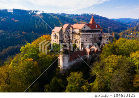 Medieval castle of Pernstein on a hill in the forest. South Moravian region.  104633125