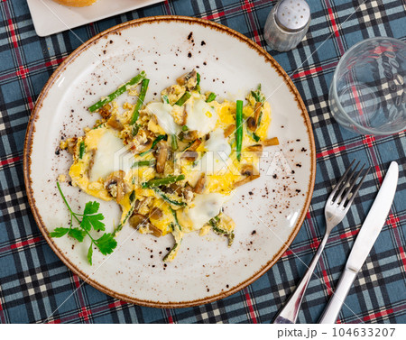 Tasty scrambled eggs with asparagus and mushrooms Tasty scrambled eggs with asparagus and mushrooms 104633207