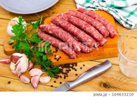 Traditional Catalan raw pork sausage longaniza ready for grilling Traditional Catalan raw pork sausage longaniza ready for grilling 104633210