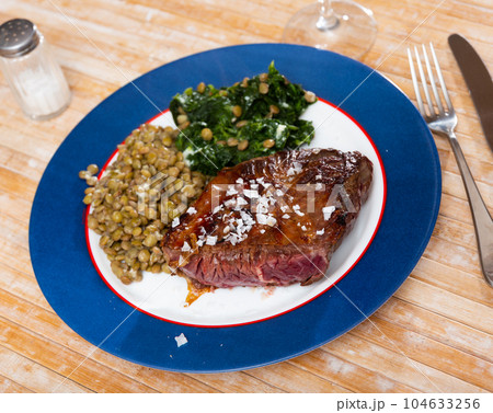 Grilled veal tenderloin with stewed lentils and spinach Grilled veal tenderloin with stewed lentils and spinach 104633256