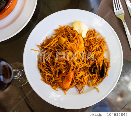 Tasty noodles with prawns and mussels with sauce Tasty noodles with prawns and mussels with sauce 104633842