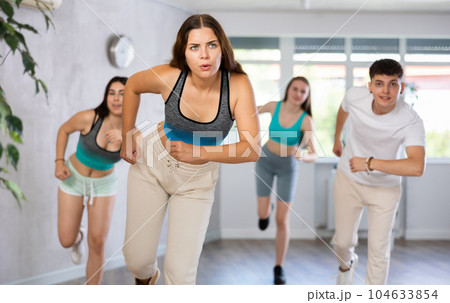 Girl teen perform choreographic exercise and teach energetic waacking dance with friends 104633854