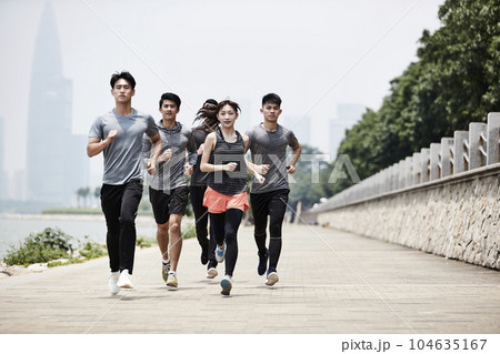 group of five young asian adult men and woman running training outdoors 104635167