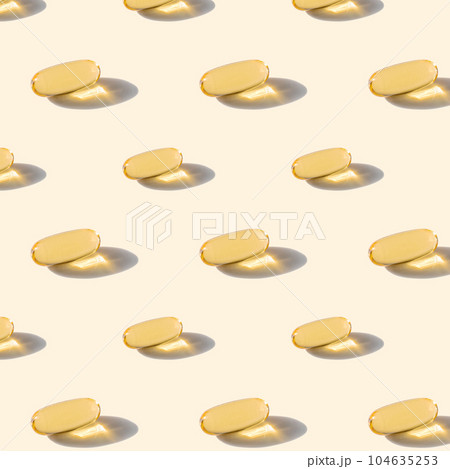 A pattern of omega capsules on a beige background. 104635253