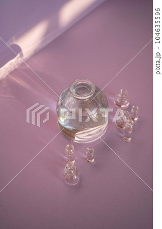 Beautiful abstract background with glass containers on a purple background. 104635596