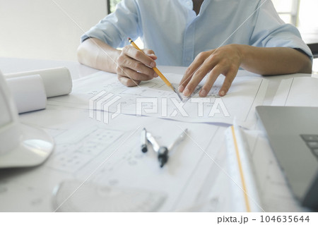 Engineer and architect working with new project. Engineer and architect working with new project. 104635644