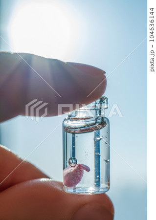 A bottle of cosmetic gel on a sky background. A bottle of cosmetic gel on a sky background. 104636144