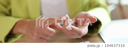 Businesswoman sitting at workplace and counting on fingers Businesswoman sitting at workplace and counting on fingers 104637310