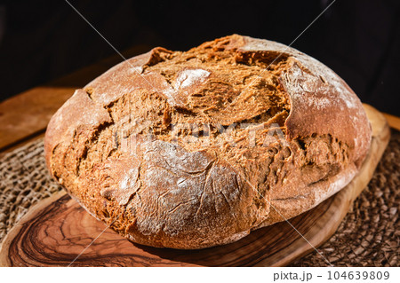 Freshly baked artisan rye bread on the table, close-up, selective focus. Homemade bread with whole wheat flour. Products from the farm shop 104639809