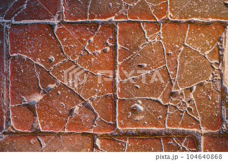 Old stone tiles on the floor of the castle, cracked terracotta tiles, idea for a background or screensaver, destruction and use of natural materials 104640868