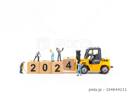 Miniature people , Worker team create a wooden block with the number 2024 Miniature people , Worker team create a wooden block with the number 2024 104644211