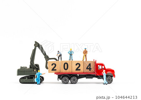 Miniature people , Worker team create a wooden block with the number 2024 104644213
