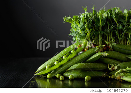 Fresh pea pods and microgreen sprouts. 104645270