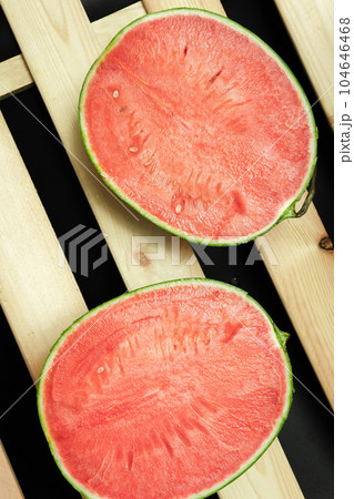 The watermelon placed on a wooden board. The watermelon placed on a wooden board. 104646468
