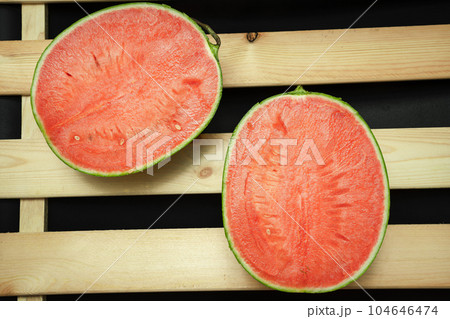The watermelon placed on a wooden board. The watermelon placed on a wooden board. 104646474