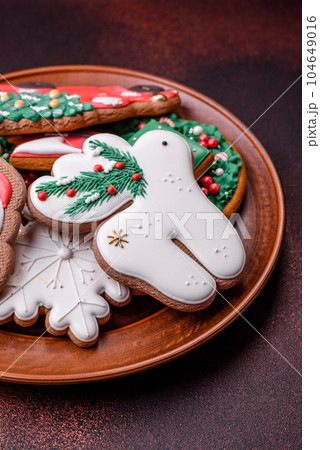 Beautiful delicious Christmas gingerbread on a concrete texture background Beautiful delicious Christmas gingerbread on a concrete texture background 104649016