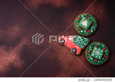 Beautiful delicious Christmas gingerbread on a concrete texture background Beautiful delicious Christmas gingerbread on a concrete texture background 104649036
