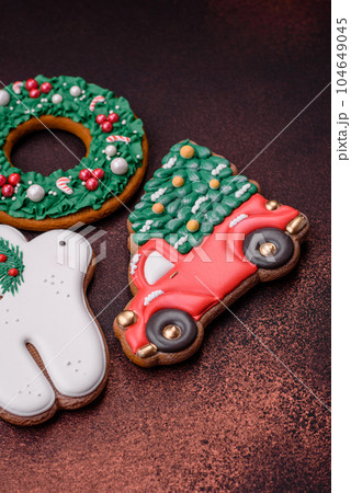 Beautiful delicious Christmas gingerbread on a concrete texture background Beautiful delicious Christmas gingerbread on a concrete texture background 104649045