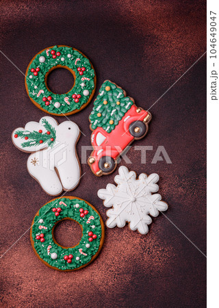 Beautiful delicious Christmas gingerbread on a concrete texture background Beautiful delicious Christmas gingerbread on a concrete texture background 104649047