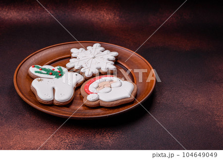 Beautiful delicious Christmas gingerbread on a concrete texture background Beautiful delicious Christmas gingerbread on a concrete texture background 104649049