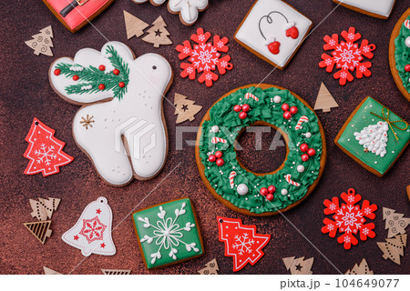 Beautiful delicious Christmas gingerbread on a concrete texture background Beautiful delicious Christmas gingerbread on a concrete texture background 104649077