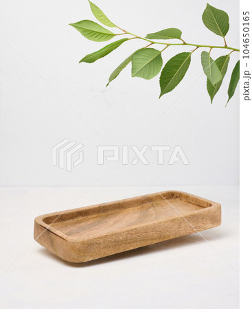 Rectangular brown wooden stand on a white background, a place to display cosmetics and products Rectangular brown wooden stand on a white background, a place to display cosmetics and products 104650165