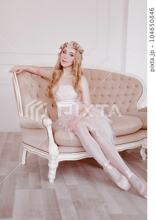 picture of young blonde woman wearing wreath of flowers, spring tender and romantic portrait, fashion retouched shot 104650846