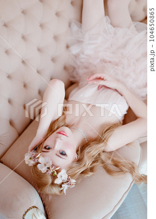picture of young blonde woman wearing wreath of flowers, spring tender and romantic portrait, fashion retouched shot picture of young blonde woman wearing wreath of flowers, spring tender and romantic portrait, fashion retouched shot 104650865