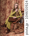 glamorous portrait of a beautiful young woman in a fur vest holding a bag 104650924
