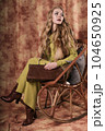 glamorous portrait of a beautiful young woman in a fur vest holding a bag 104650925
