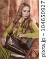 glamorous portrait of a beautiful young woman in a fur vest holding a bag 104650927