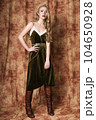 Beautiful fashion model in a velvet green dress. Vintage. Luxury style. 104650928