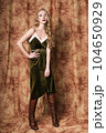 Beautiful fashion model in a velvet green dress. Vintage. Luxury style. 104650929