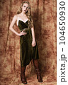Beautiful fashion model in a velvet green dress. Vintage. Luxury style. 104650930