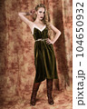 Beautiful fashion model in a velvet green dress. Vintage. Luxury style. 104650932