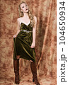 Beautiful fashion model in a velvet green dress. Vintage. Luxury style. 104650934