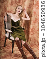 Beautiful fashion model in a velvet green dress. Vintage. Luxury style. 104650936