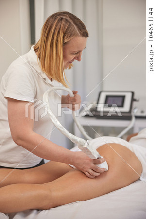 lifting body, Anti-cellulite, modern medical. Anti-cellulite roller-vacuum massage procedure is available in beauty salon to treat cellulite problem areas. Body care professional equipment 104651144