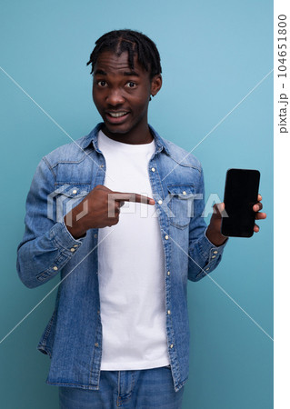 smiling african man with black dreadlocks using smartphone smiling african man with black dreadlocks using smartphone 104651800