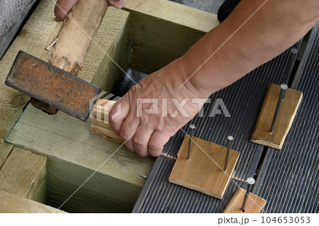 Construction and assembly of larch floor. Outdoors. Construction and assembly of larch floor. Outdoors. 104653053