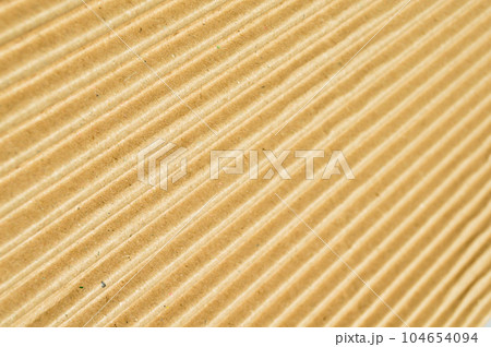Brown and beige colored corrugated cardboard detail 104654094
