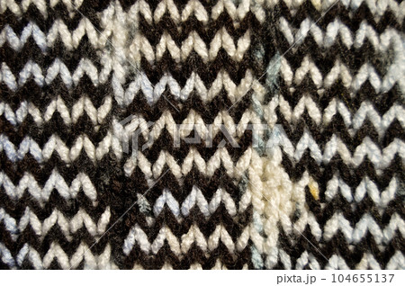 Handmade knitted fabric white brown wool background texture Handmade knitted fabric white brown wool background texture 104655137