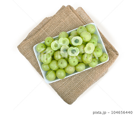indian gooseberry in   white plate on sackcloth  white back ground. 104656440