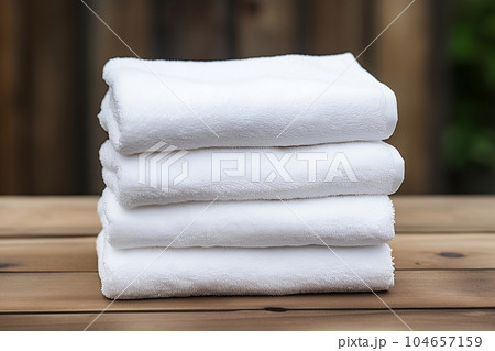 A set of white towels on the shelf 104657159